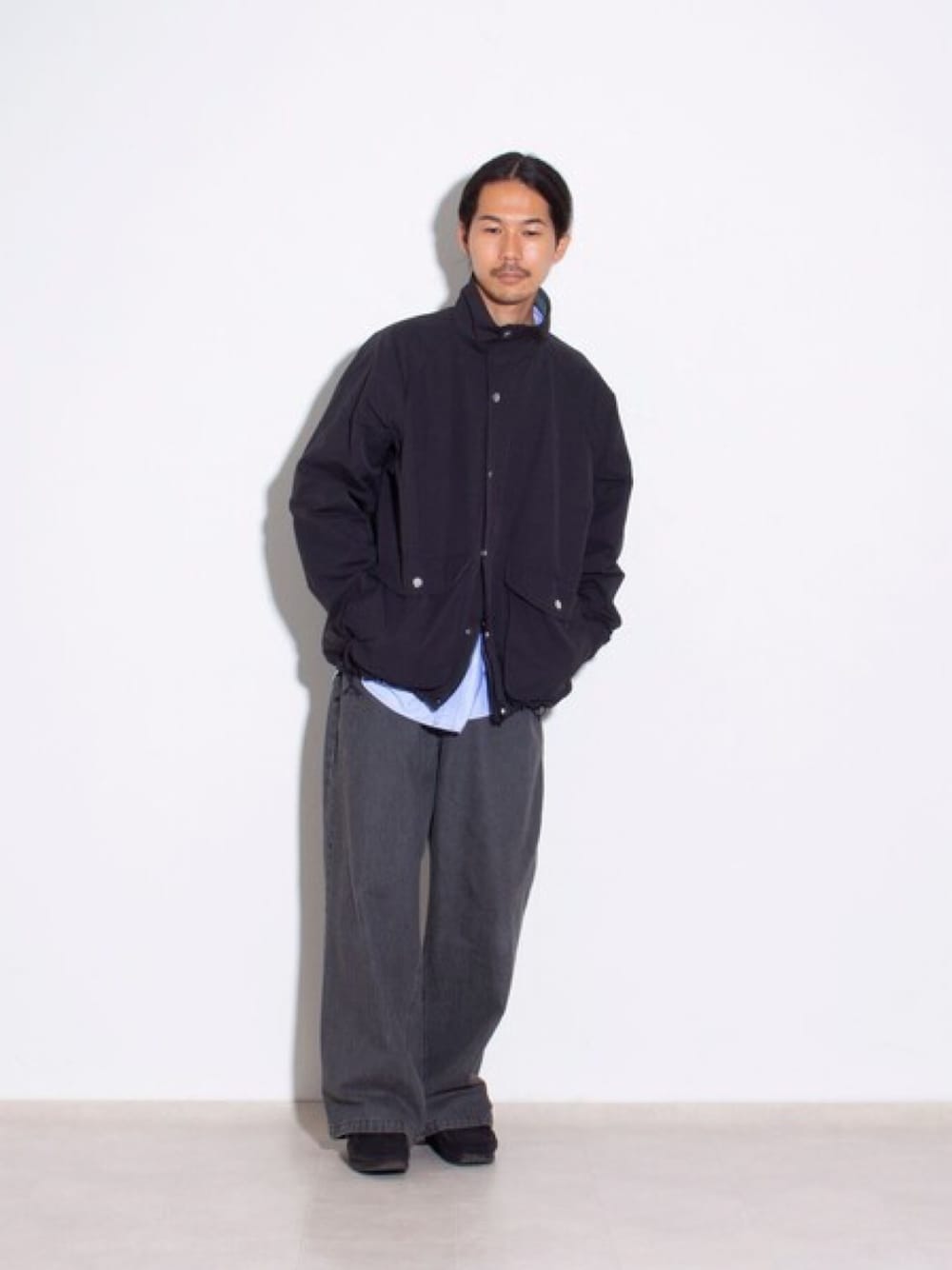 ブラック系のブルゾン、ブルー系のシャツ/ブラウス、ブラック系のデニムパンツを着用したメンズの秋コーディネートの1枚目の写真