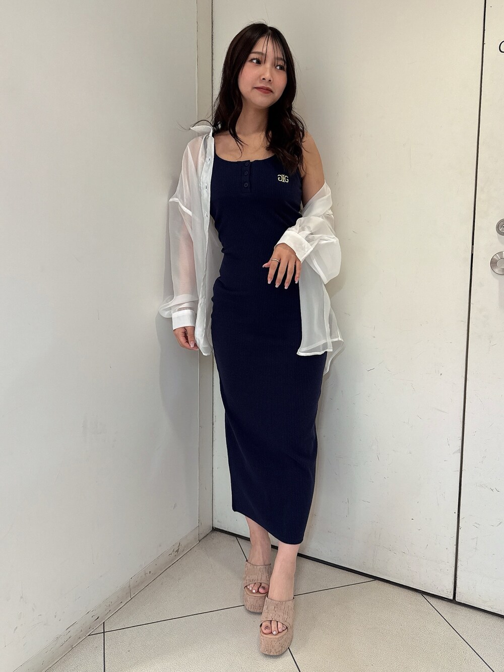 ブルー系のワンピース、ホワイト系のシャツ/ブラウス、ホワイト系のサンダルを着用したレディースの春コーディネートの1枚目の写真