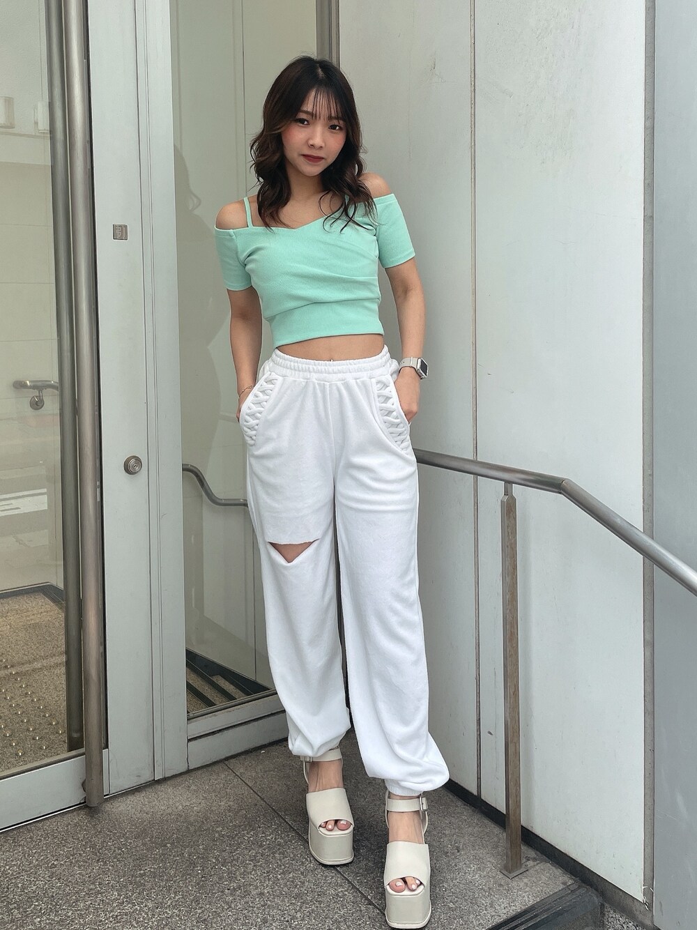 グリーン系のTシャツ/カットソー、ホワイト系のその他パンツ、ホワイト系のサンダルを着用したレディースの春コーディネートの1枚目の写真