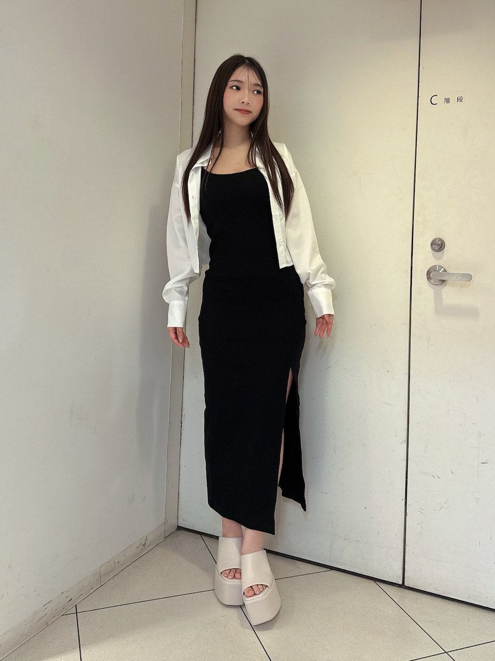 ブラック系のワンピース、ホワイト系のシャツ/ブラウス、ホワイト系のサンダルを着用したレディースの夏コーディネートの1枚目の写真