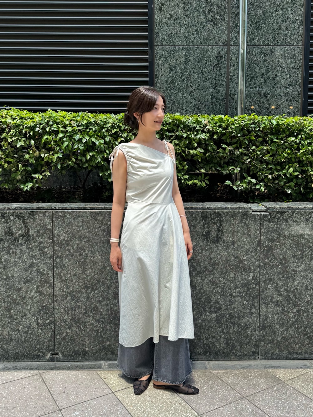 グレー系のワンピース、グレー系のデニムパンツを着用したレディースの夏コーディネートの1枚目の写真