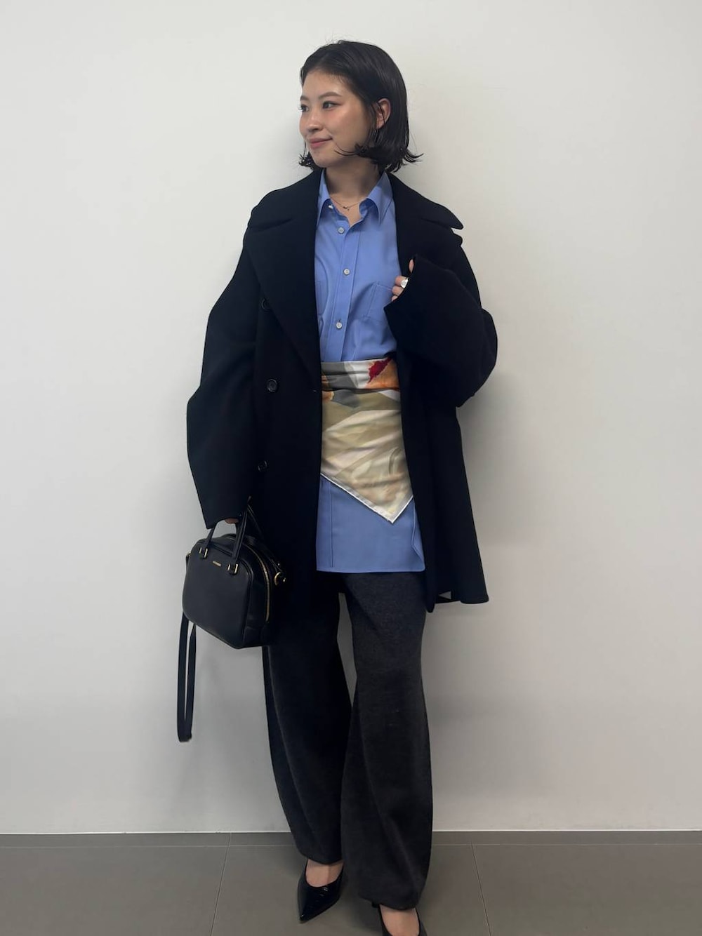 グレー系のその他パンツ、ブラック系のピーコート、グレー系のストール/ショールを着用したレディースの秋コーディネートの1枚目の写真