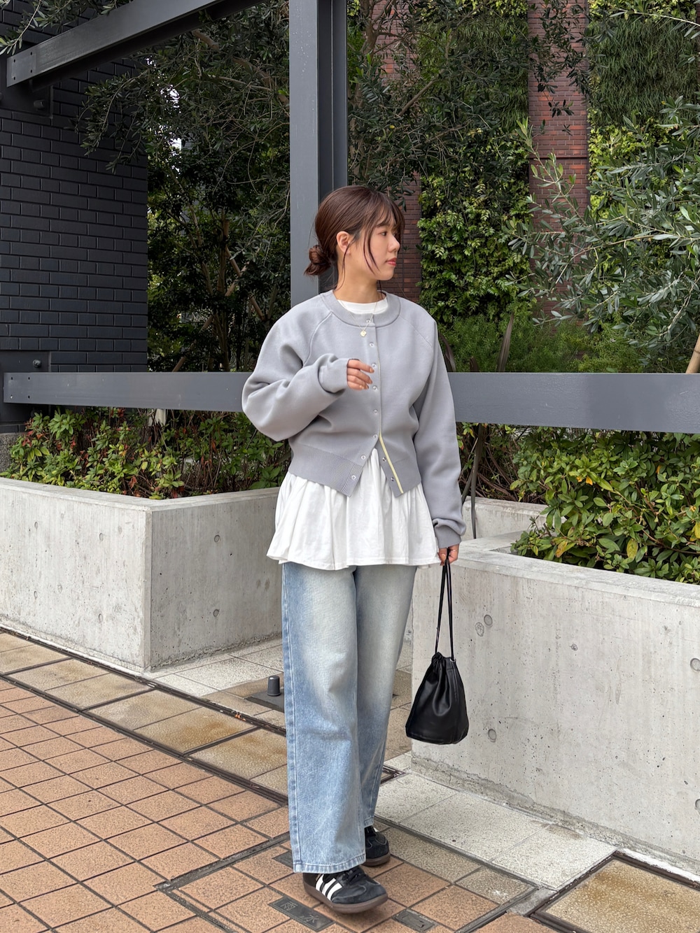 ホワイト系のTシャツ/カットソー、グレー系のカーディガン/ボレロ、ブルー系のデニムパンツを着用したレディースの春コーディネートの1枚目の写真