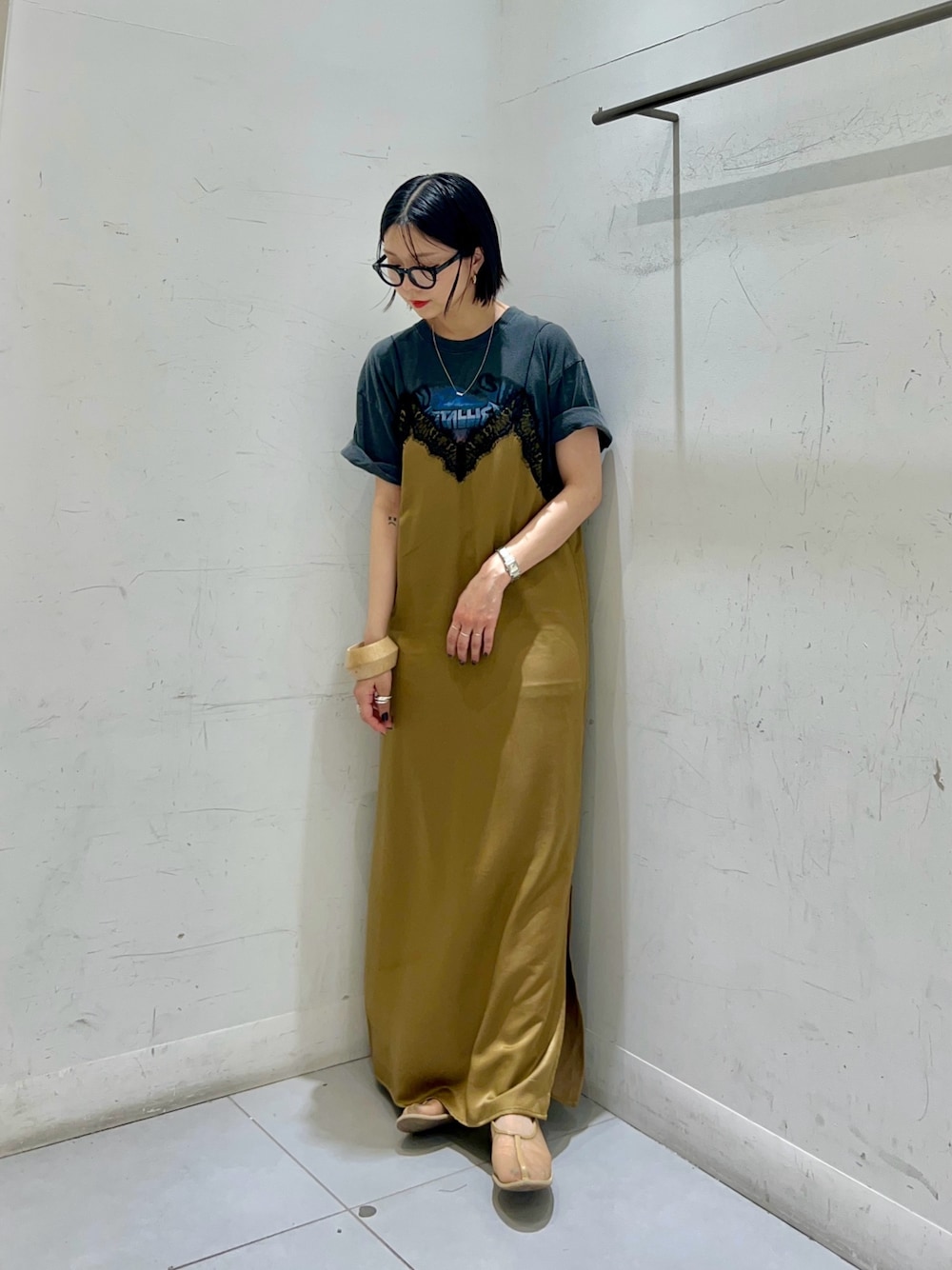 ブラック系のTシャツ/カットソー、ベージュ系のワンピース、ブラック系のメガネを着用したレディースの春コーディネートの1枚目の写真