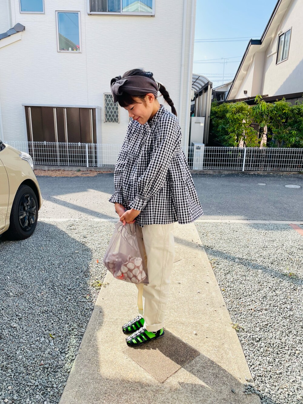 ブラック系のシャツ/ブラウス、ホワイト系のチノパンツ、ブラック系のサンダルを着用したキッズの春コーディネートの1枚目の写真