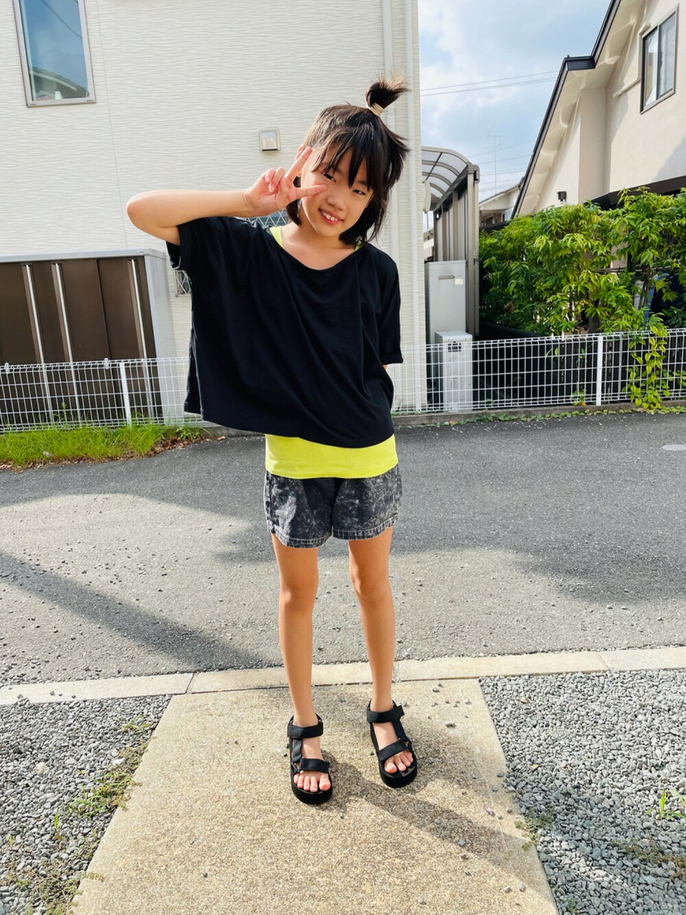 ブラック系のTシャツ/カットソー、ブラック系のデニムパンツ、ブラック系のサンダルを着用したキッズの秋コーディネートの1枚目の写真