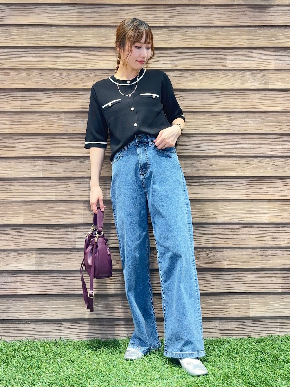 ブラック系のカーディガン/ボレロ、ブルー系のデニムパンツ、レッド系のショルダーバッグを着用したレディースの秋コーディネートの1枚目の写真