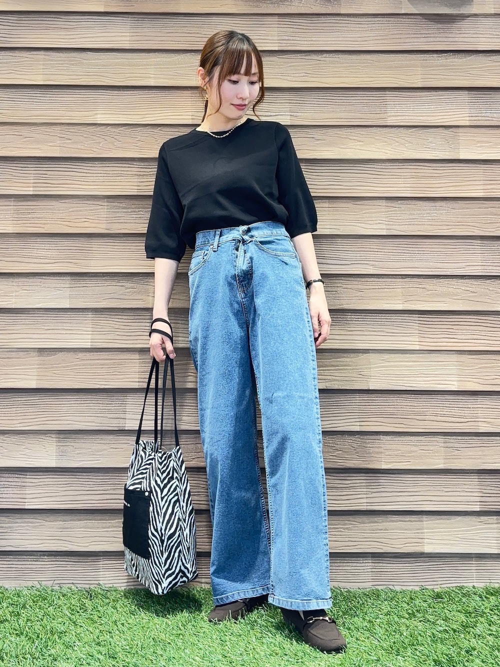 ブラック系のニット/セーター、ブラウン系のその他シューズ、ブラック系のトートバッグを着用したレディースの夏コーディネートの1枚目の写真