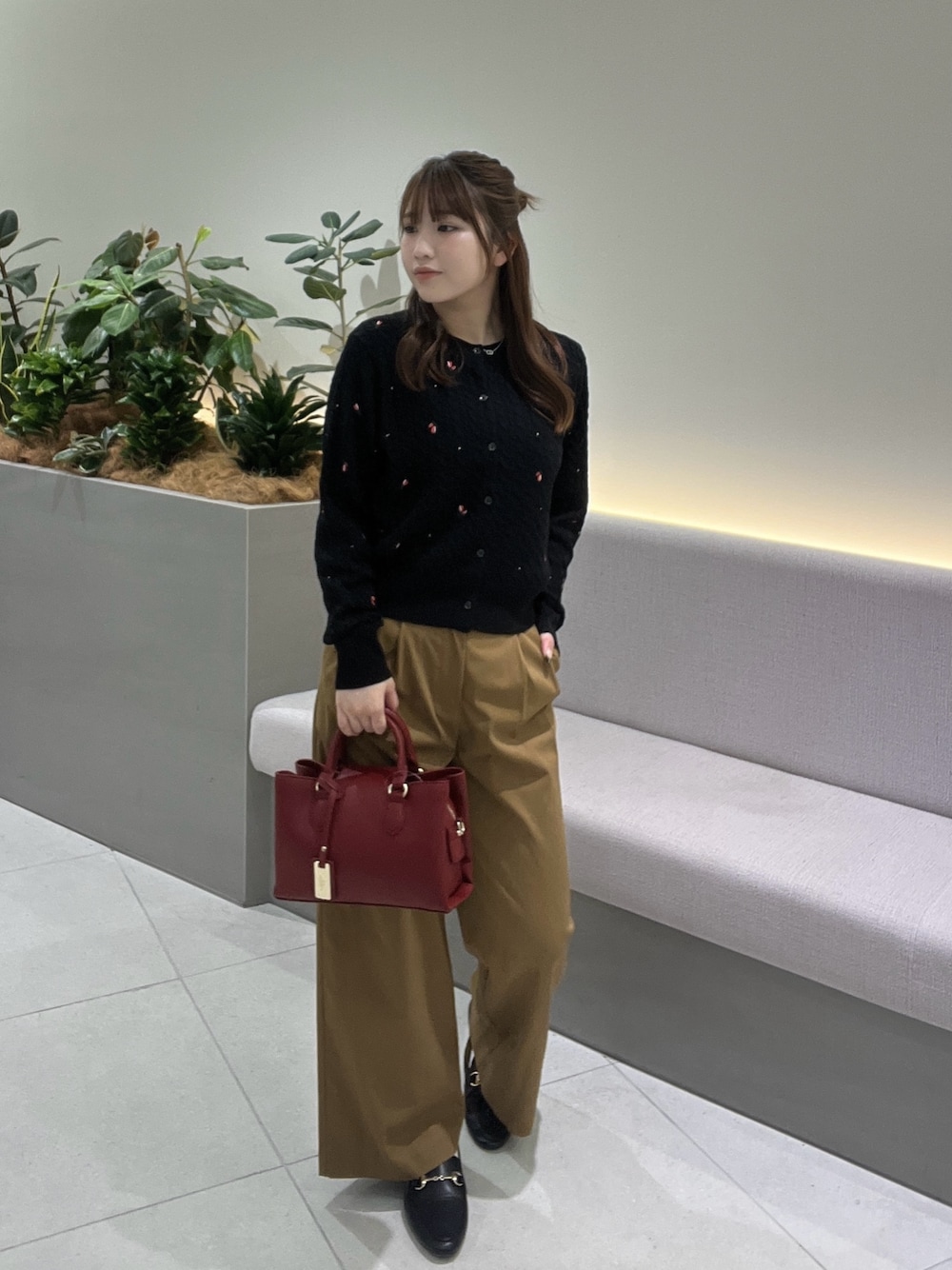ブラック系のカーディガン/ボレロ、イエロー系のその他パンツ、レッド系のショルダーバッグを着用したレディースの秋コーディネートの1枚目の写真