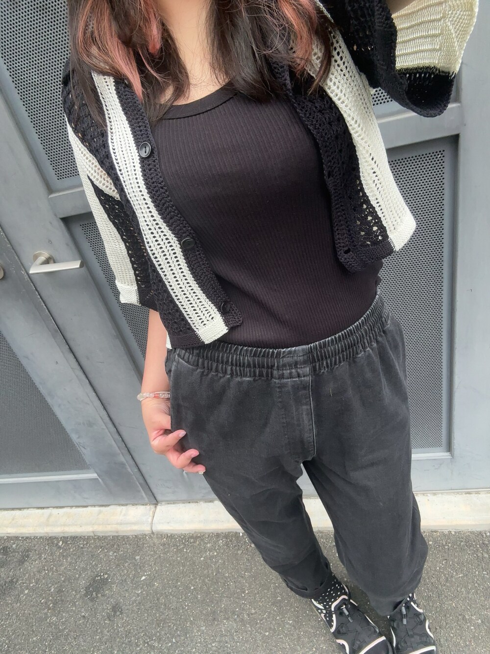 ブラック系のパンツ、ブラック系のタンクトップ、ブラック系のサンダルを着用したレディースの夏コーディネートの1枚目の写真