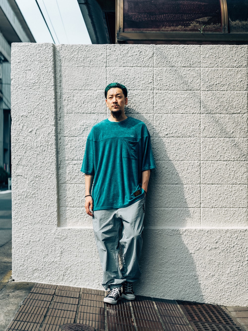 グリーン系のTシャツ/カットソー、グレー系のその他パンツを着用したメンズの夏コーディネートの1枚目の写真