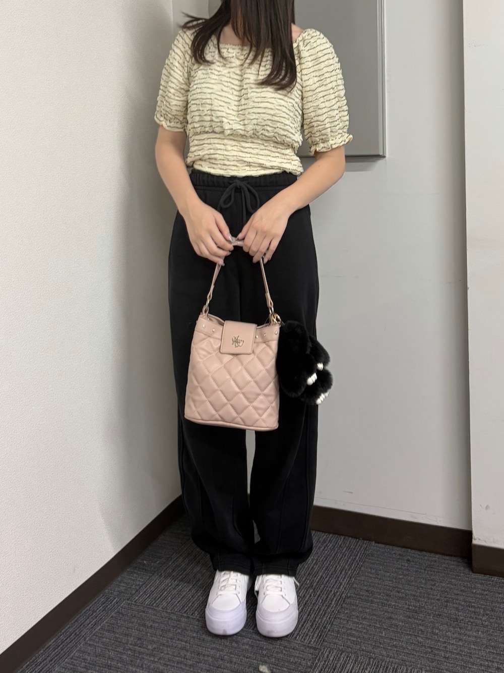 ピンク系のショルダーバッグを着用したレディースの夏コーディネートの1枚目の写真