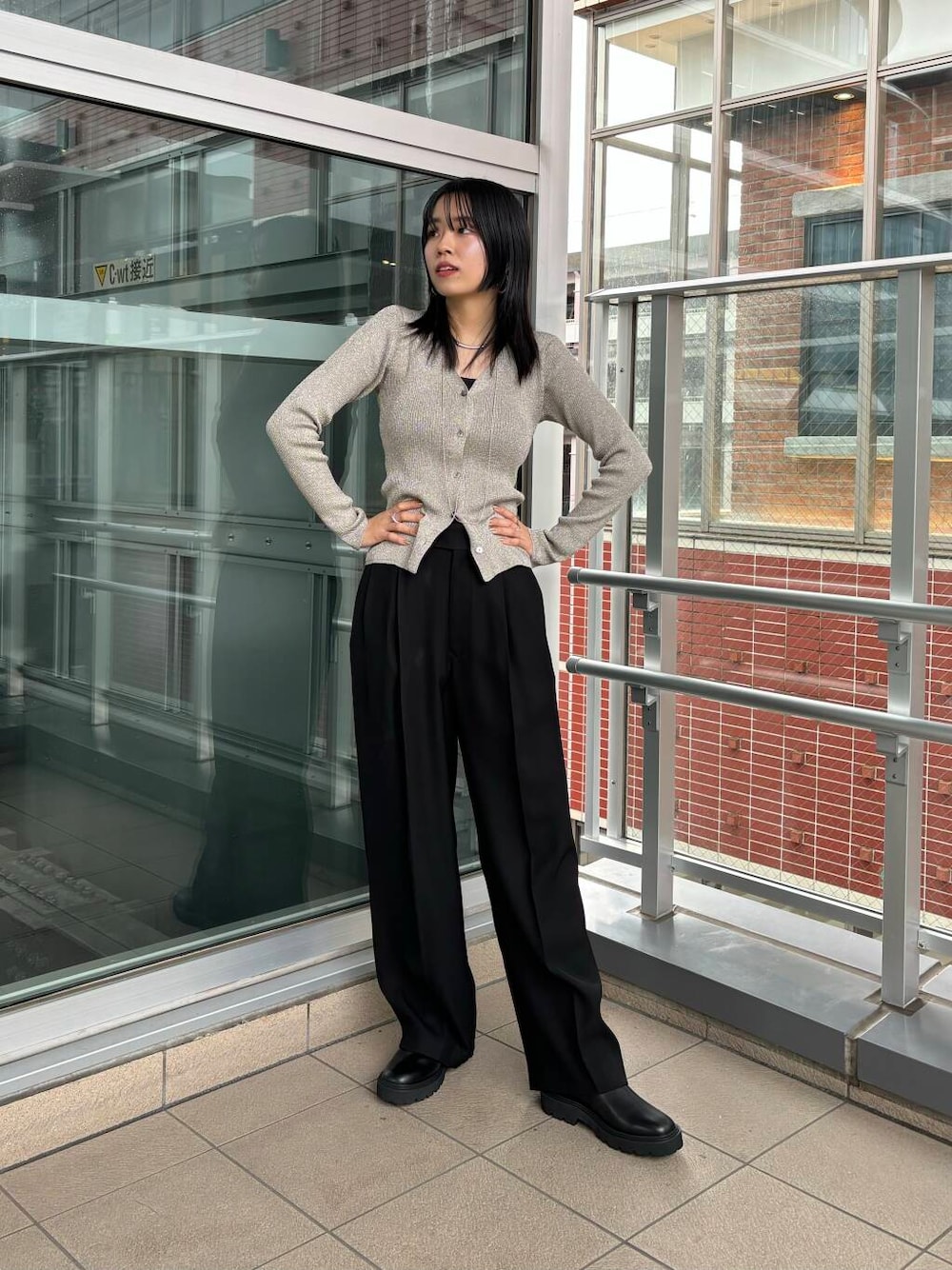 ブラック系のその他パンツ、その他のカーディガン/ボレロ、ブラック系のブーツを着用したレディースの秋コーディネートの1枚目の写真