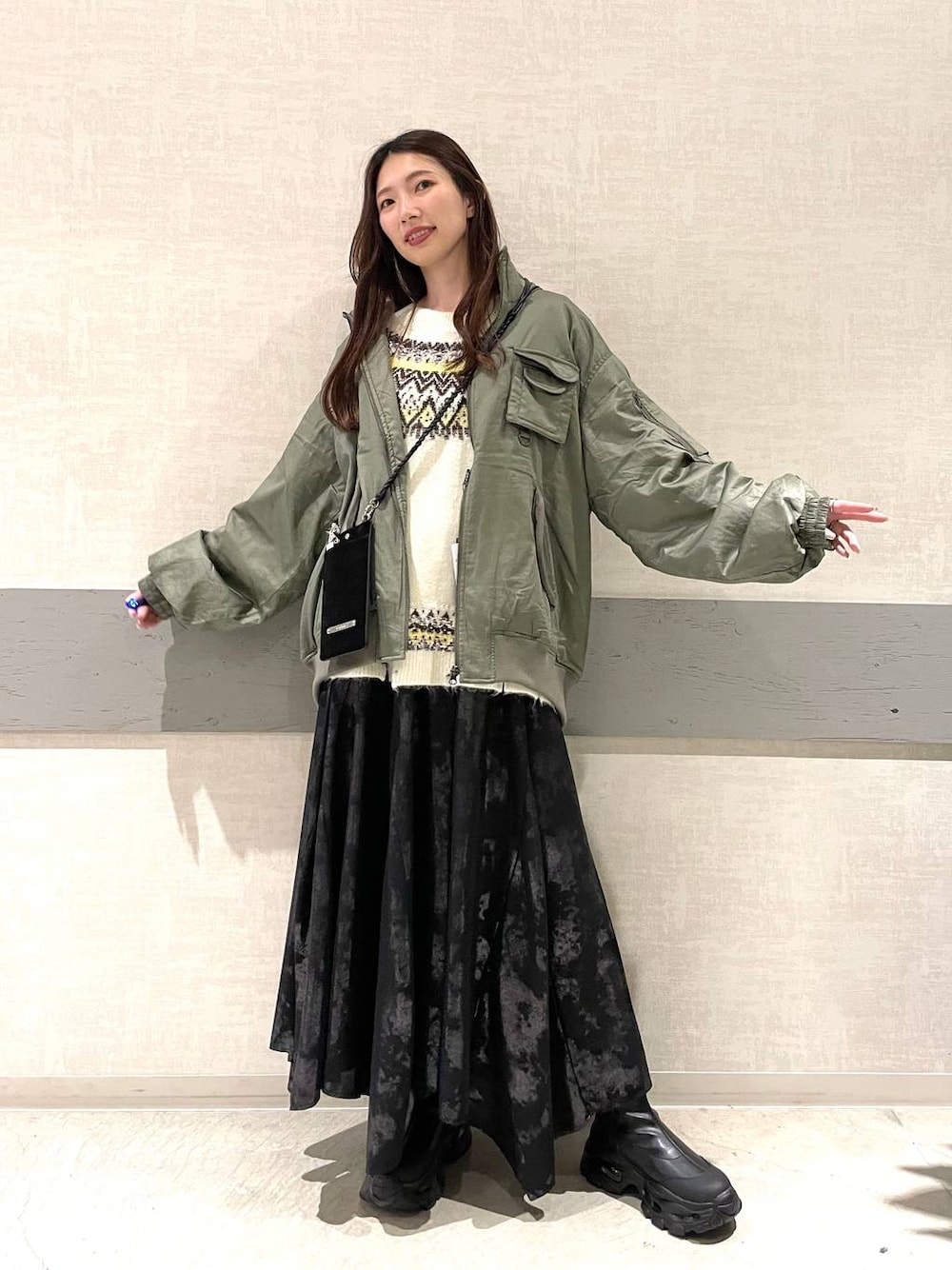 ブラック系のブーツ、グリーン系のブルゾン、ベージュ系のTシャツ/カットソーを着用したレディースの秋コーディネートの1枚目の写真