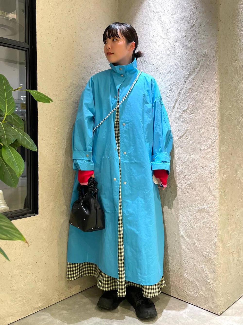 ブラック系のハンドバッグ、グリーン系のワンピース、ブルー系のブルゾンを着用したレディースの春コーディネートの1枚目の写真