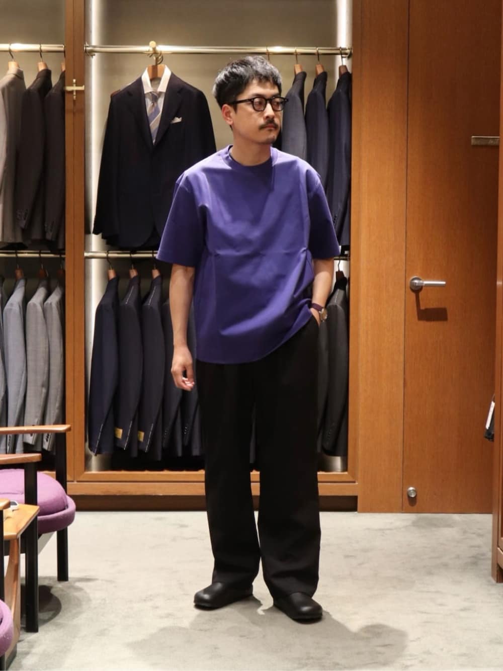 ブラック系のスラックス、ブラック系のサンダル、ブルー系のTシャツ/カットソーを着用したメンズの夏コーディネートの1枚目の写真