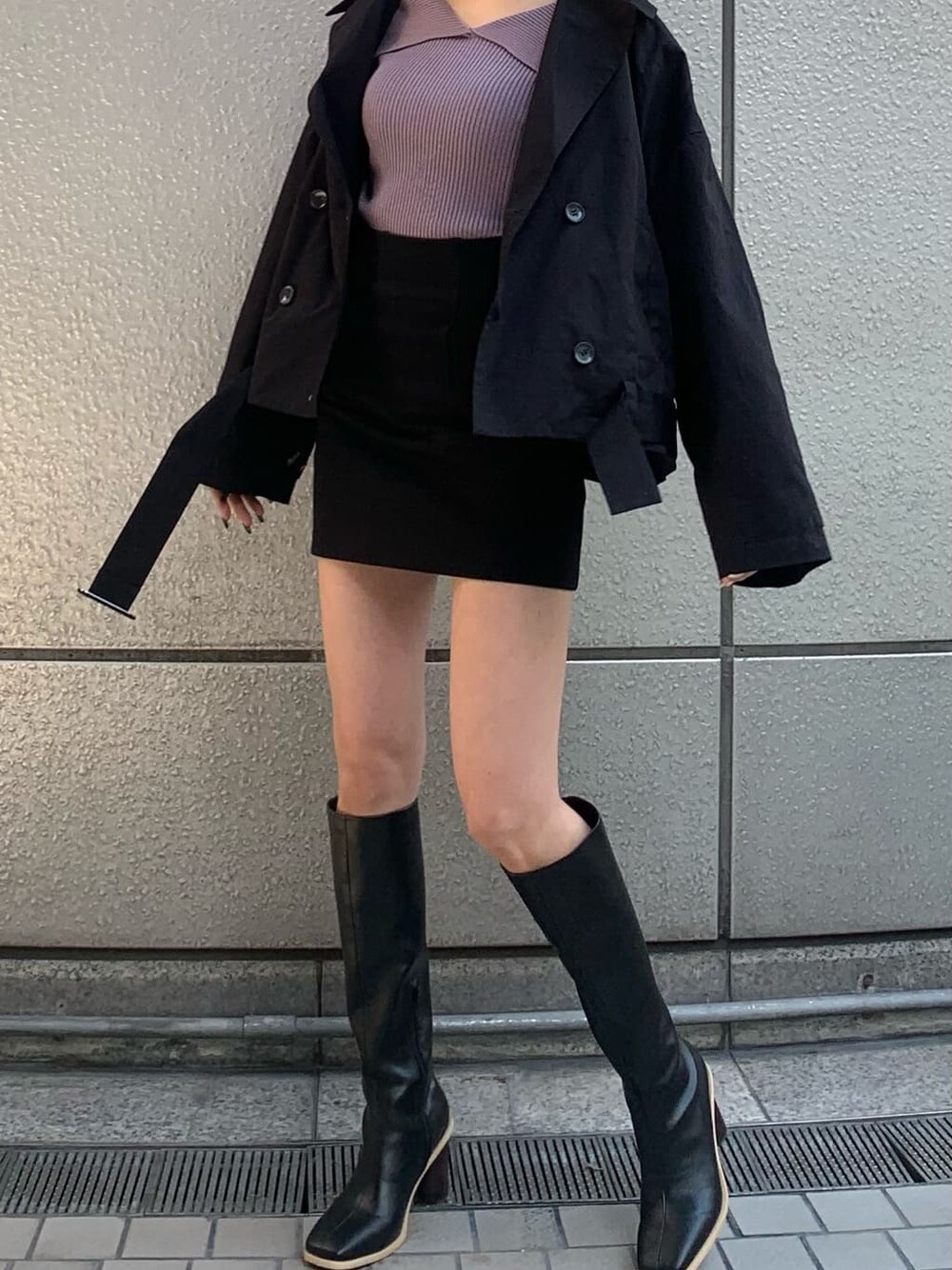 ブラック系のブーツ、パープル系のニット/セーター、ブラック系のトレンチコートを着用したレディースの冬コーディネートの1枚目の写真