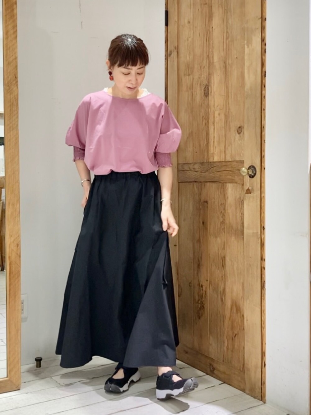 ピンク系のTシャツ/カットソー、ブラック系のスカートを着用したレディースの夏コーディネートの3枚目の写真