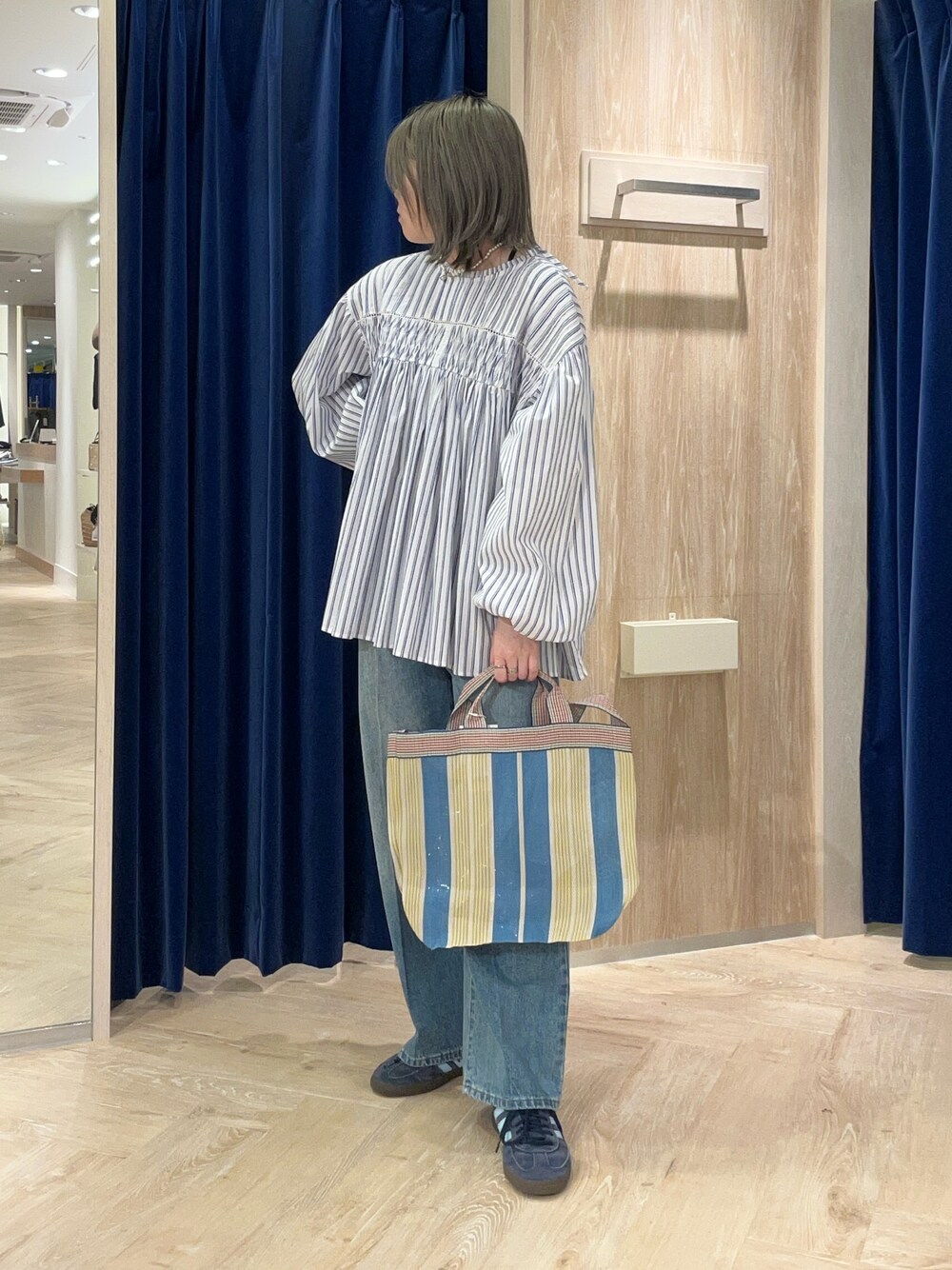 ホワイト系のシャツ/ブラウス、ブルー系のデニムパンツを着用したレディースの春コーディネートの1枚目の写真