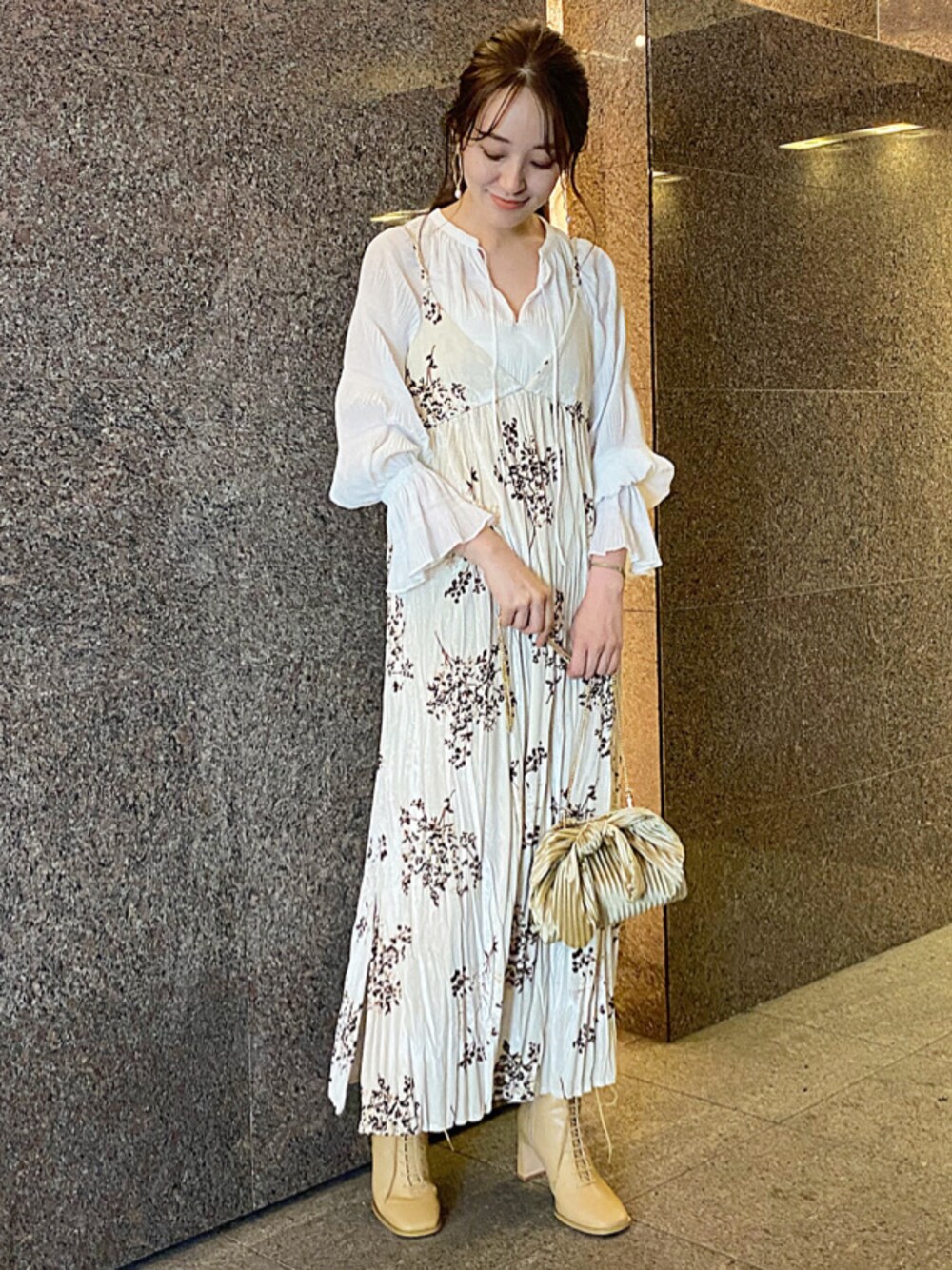 ベージュ系のワンピース、ホワイト系のシャツ/ブラウス、ベージュ系のクラッチバッグを着用したレディースの秋コーディネートの1枚目の写真