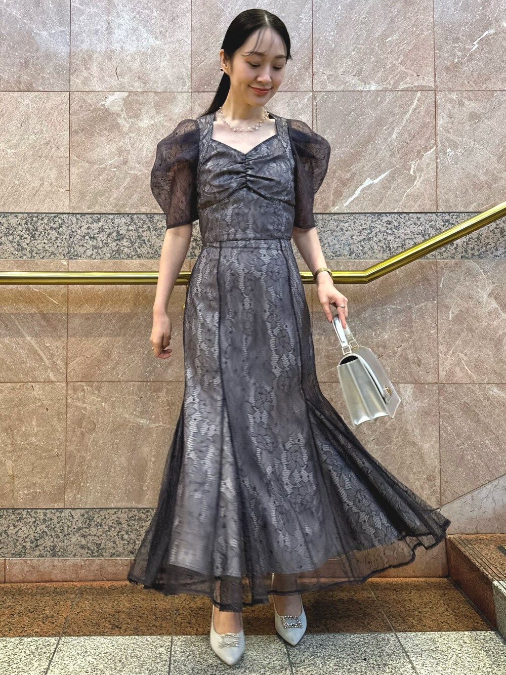 パープル系のシャツ/ブラウス、シルバー系のハンドバッグ、シルバー系のパンプスを着用したレディースの冬コーディネートの1枚目の写真