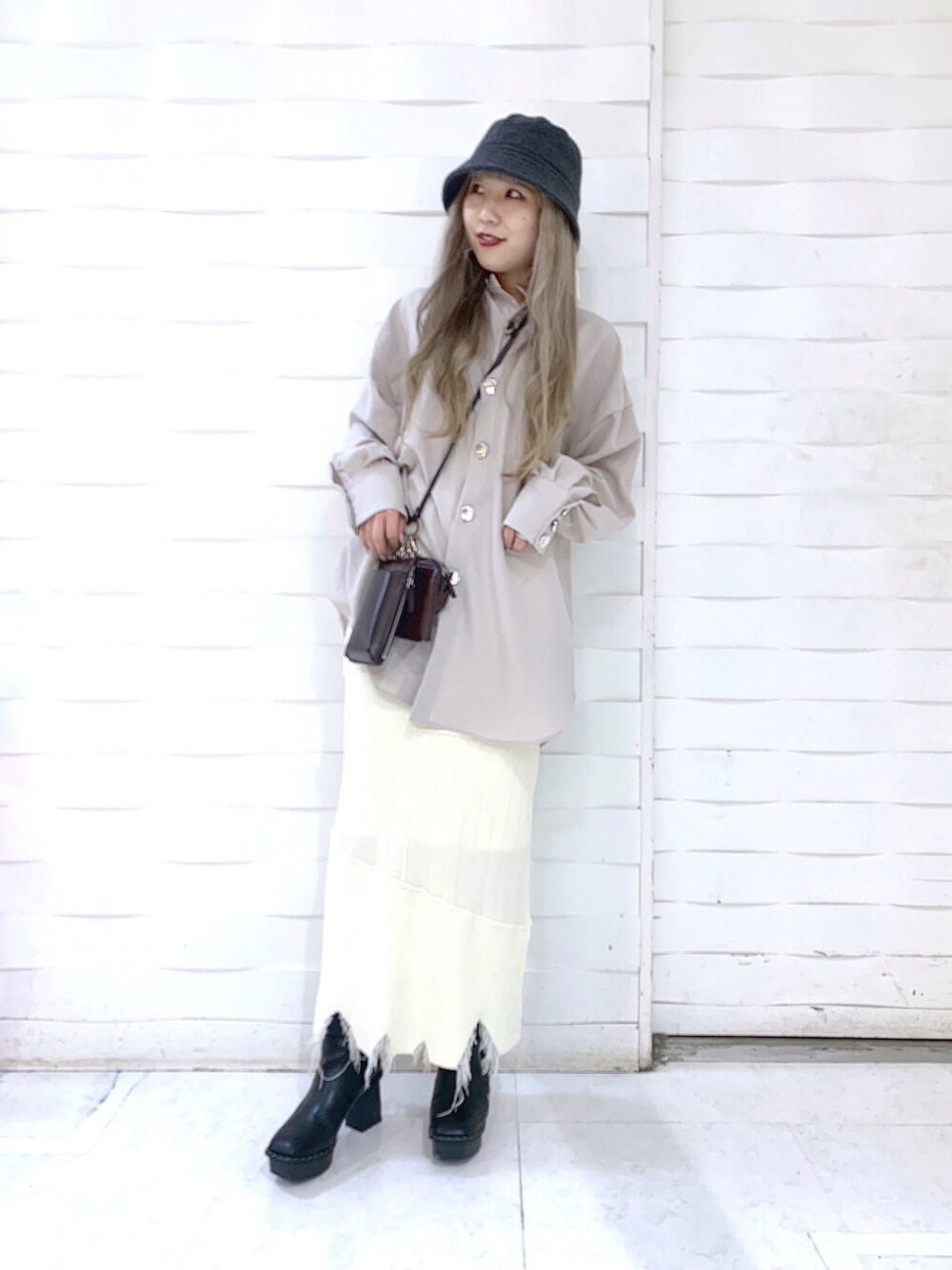 ベージュ系のシャツ/ブラウス、ブラック系のスカート、ブラウン系のショルダーバッグを着用したレディースの冬コーディネートの2枚目の写真