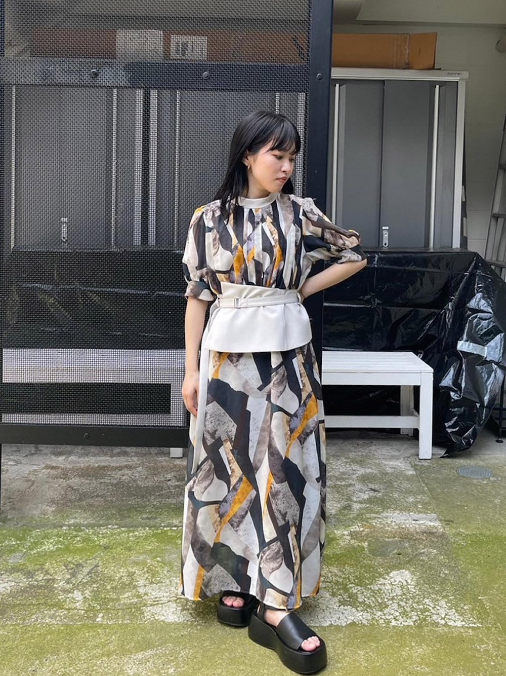 イエロー系のワンピースを着用したレディースの春コーディネートの1枚目の写真