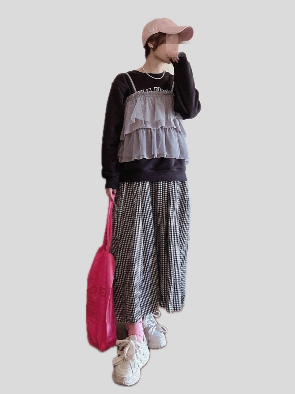 グレー系のキャミソール、ブラック系のジャンパースカート、ピンク系のトートバッグを着用したレディースの春コーディネートの1枚目の写真