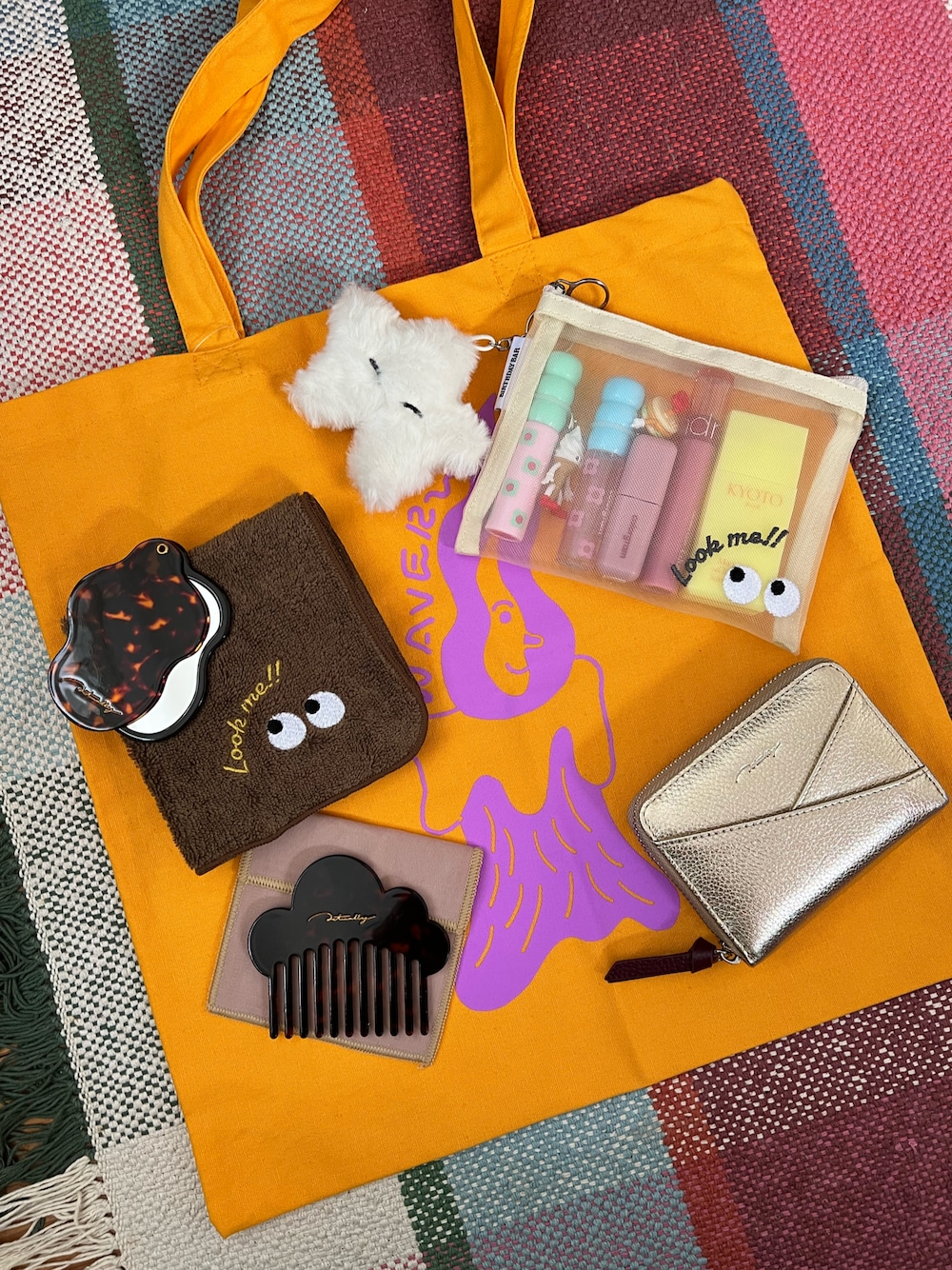 ホワイト系のポーチ、ホワイト系のチャーム、ゴールド系の財布を着用したレディースの夏コーディネートの1枚目の写真