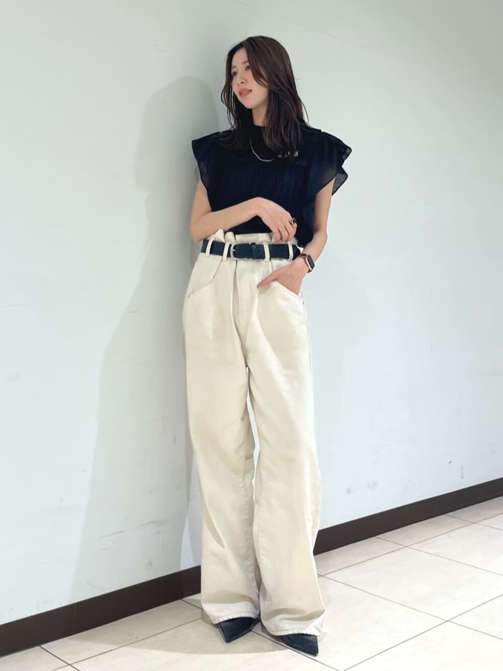 ブラック系のシャツ/ブラウス、ホワイト系のデニムパンツを着用したレディースの春コーディネートの1枚目の写真