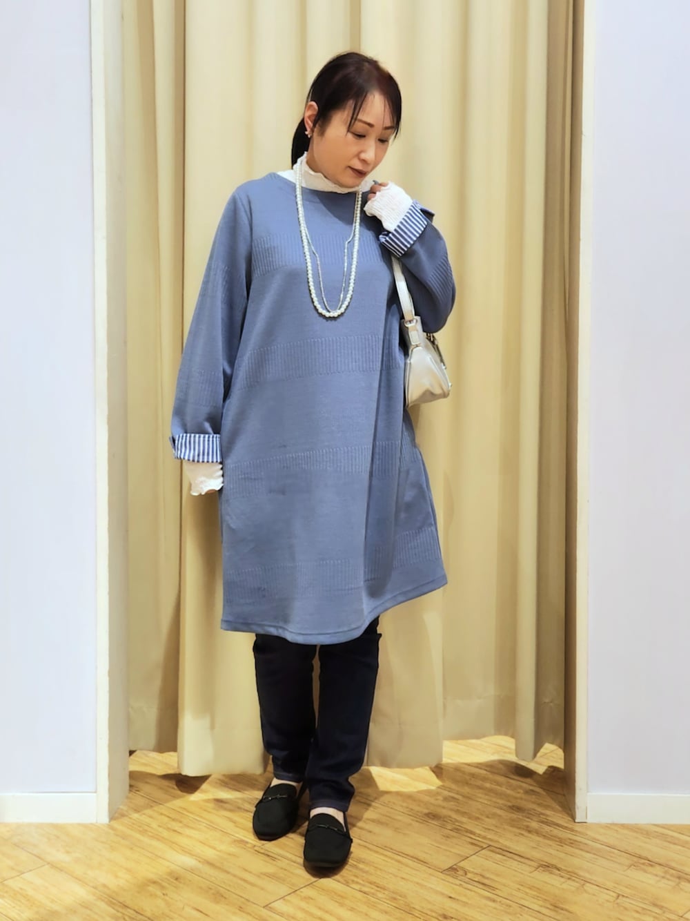 ホワイト系のTシャツ/カットソー、ブラック系のその他シューズ、ブルー系のデニムパンツを着用したレディースの冬コーディネートの1枚目の写真