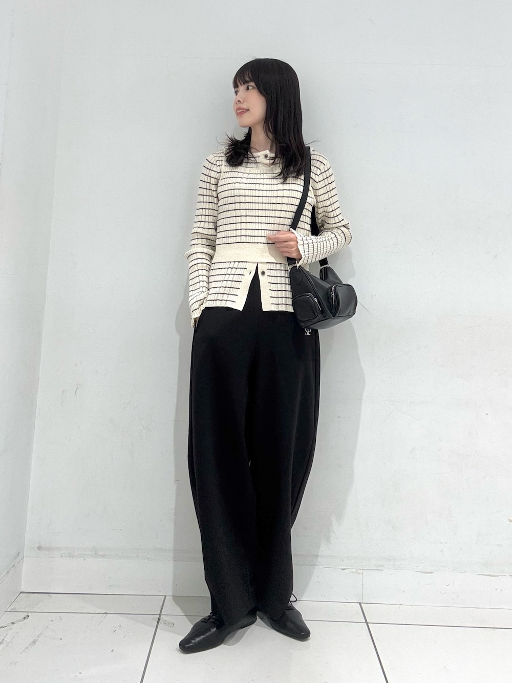 ホワイト系のニット/セーター、ブラック系のその他パンツ、ブラック系のその他シューズを着用したレディースの冬コーディネートの1枚目の写真