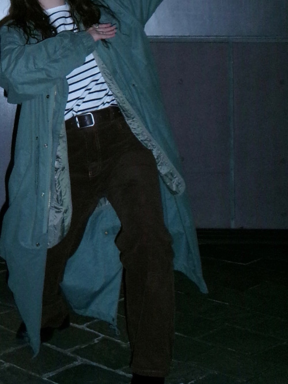 グリーン系のモッズコート、ホワイト系のTシャツ/カットソー、ブラウン系のデニムパンツを着用したレディースの秋コーディネートの1枚目の写真