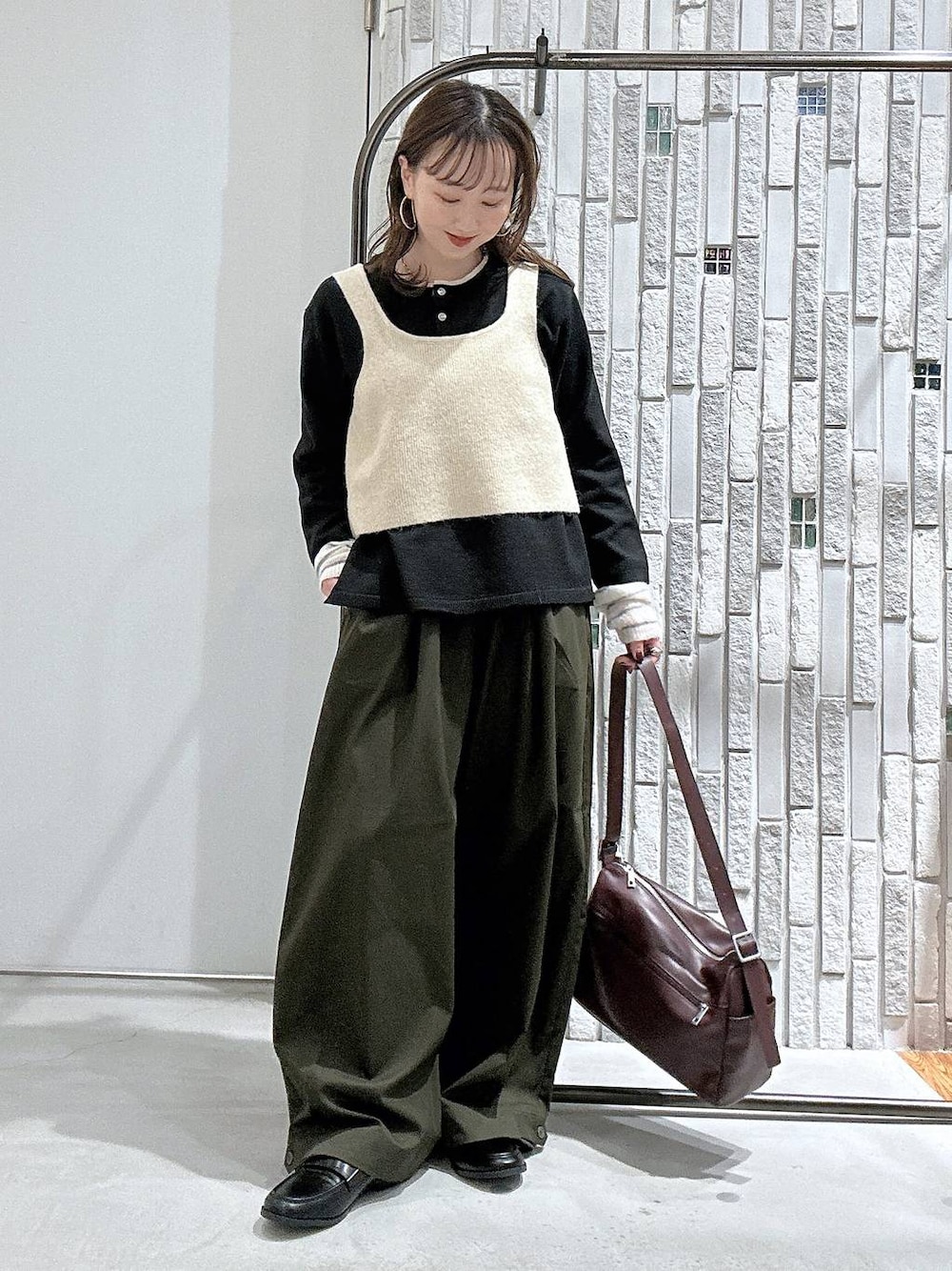 ブラック系のローファー、グリーン系のその他パンツ、ブラック系のニット/セーターを着用したレディースの秋コーディネートの1枚目の写真