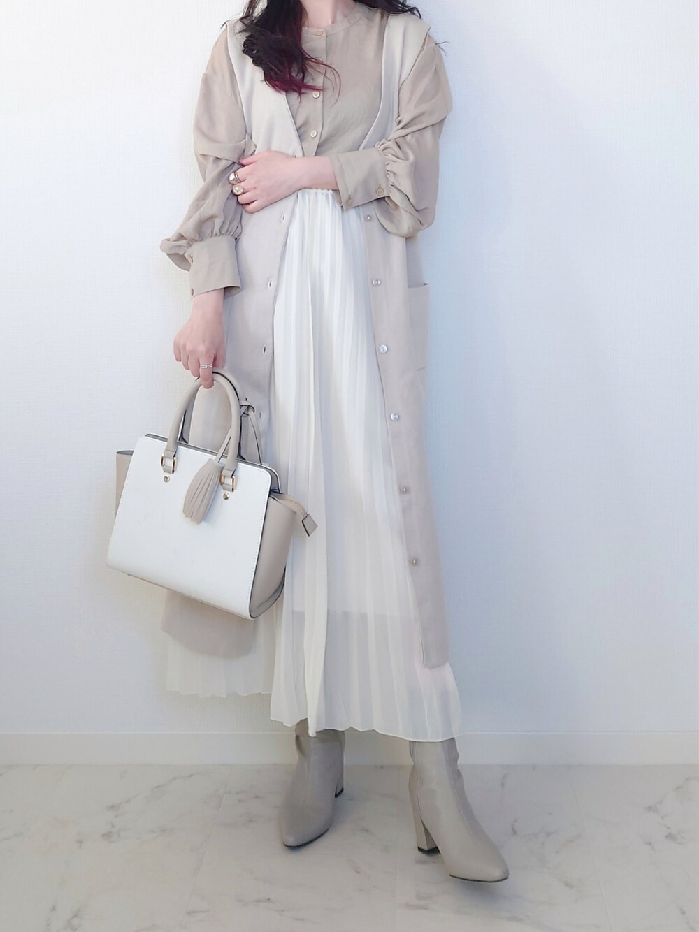 グレー系のブーツ、グレー系のビジネスバッグ、ブルー系のシャツ/ブラウスを着用したレディースの冬コーディネートの2枚目の写真