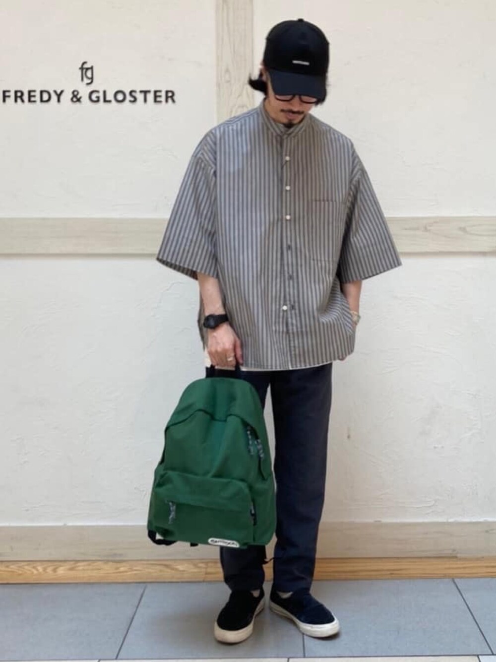 グレー系のシャツ/ブラウス、グレー系のその他パンツ、グリーン系のバックパック/リュックを着用したメンズの春コーディネートの1枚目の写真