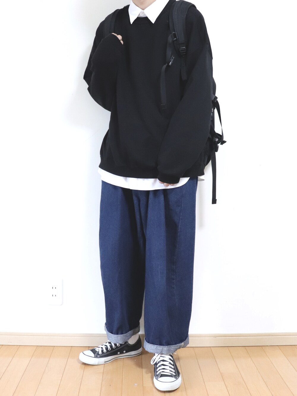 ブルー系のデニムパンツ、ブラック系のバックパック/リュック、ホワイト系のシャツ/ブラウスを着用したメンズの春コーディネートの1枚目の写真