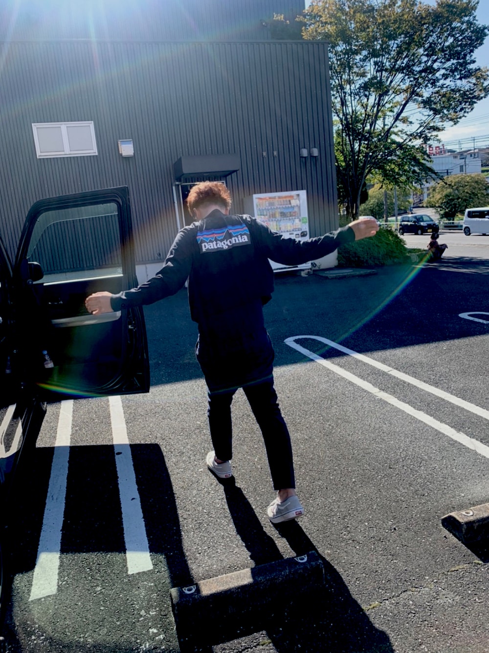 ブラック系のTシャツ/カットソー、ブルー系のチノパンツ、シルバー系のスニーカーを着用したメンズの秋コーディネートの1枚目の写真