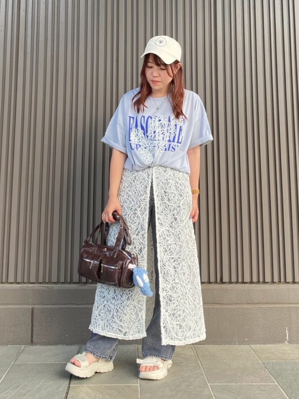 ブルー系のTシャツ/カットソー、ベージュ系のワンピース、ブラック系のデニムパンツを着用したレディースの秋コーディネートの1枚目の写真
