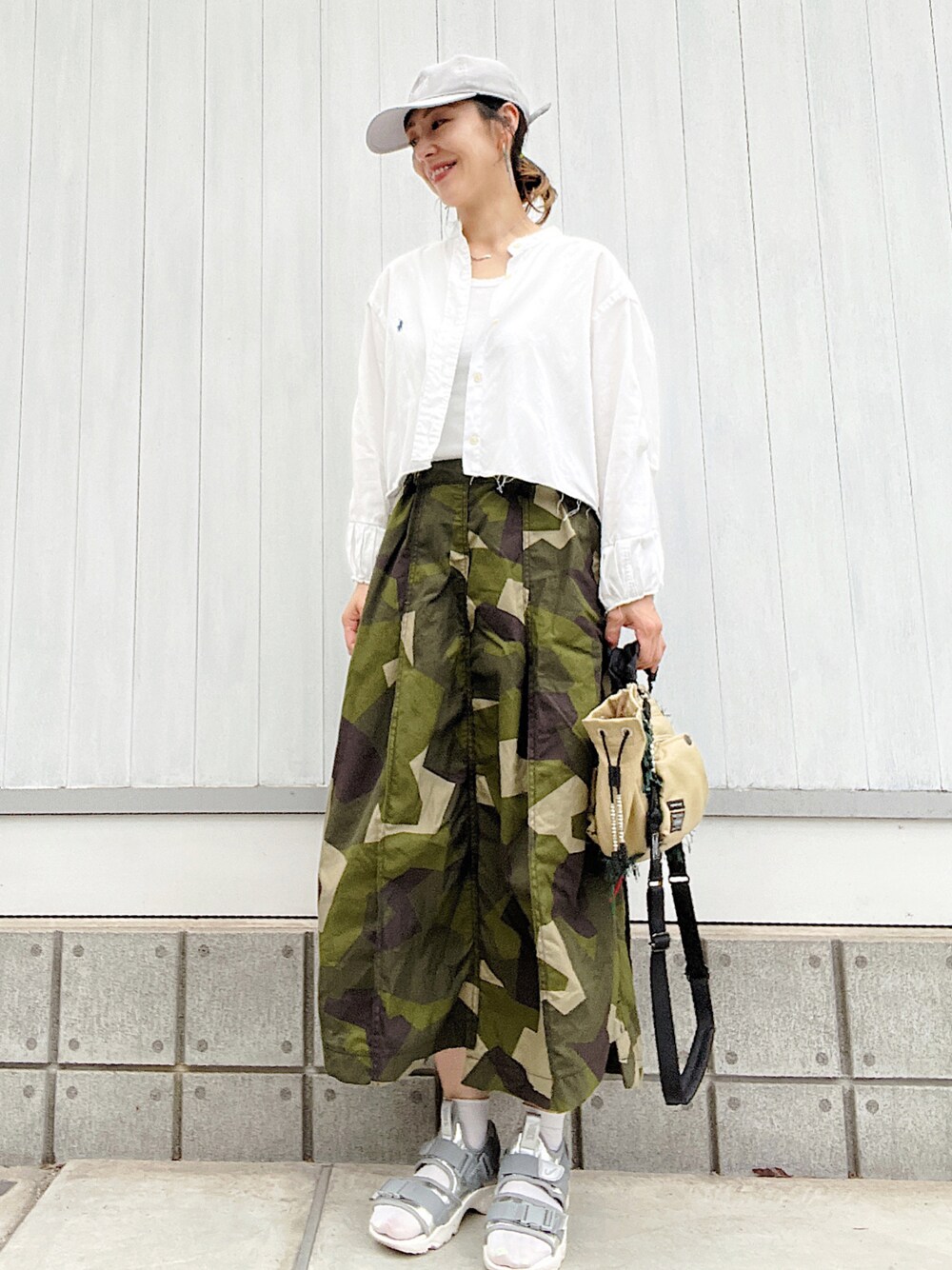 シルバー系のサンダル、その他のスカート、ベージュ系のショルダーバッグを着用したレディースの夏コーディネートの1枚目の写真