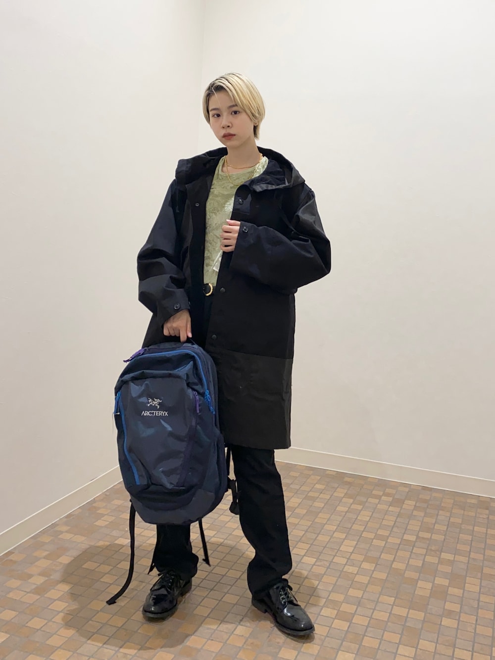 ブラック系のジャケット/アウター、グリーン系のTシャツ/カットソー、ブルー系のバックパック/リュックを着用したレディースの秋コーディネートの1枚目の写真