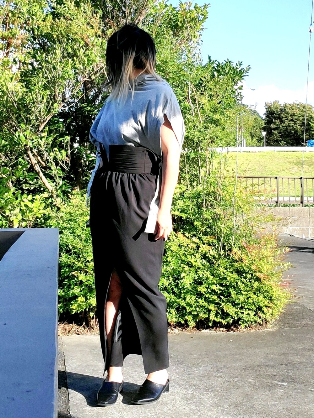 ブラック系のパンプス、ブラック系のパーカー、ブラック系のスカートを着用したレディースの秋コーディネートの1枚目の写真