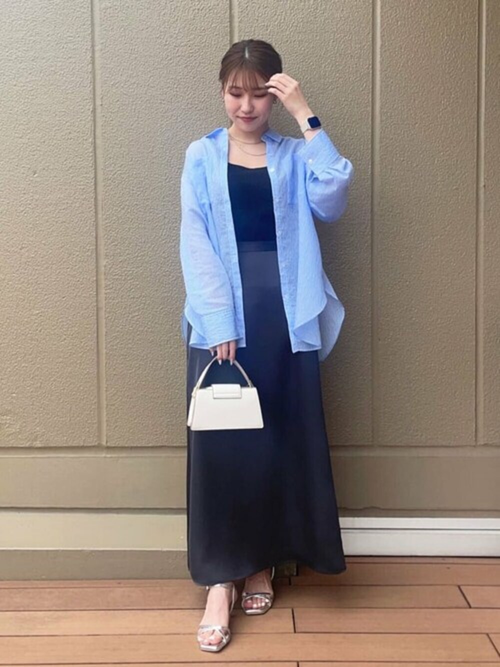 ブルー系のシャツ/ブラウス、ブラック系のスカート、ブラック系のタンクトップを着用したレディースの春コーディネートの1枚目の写真