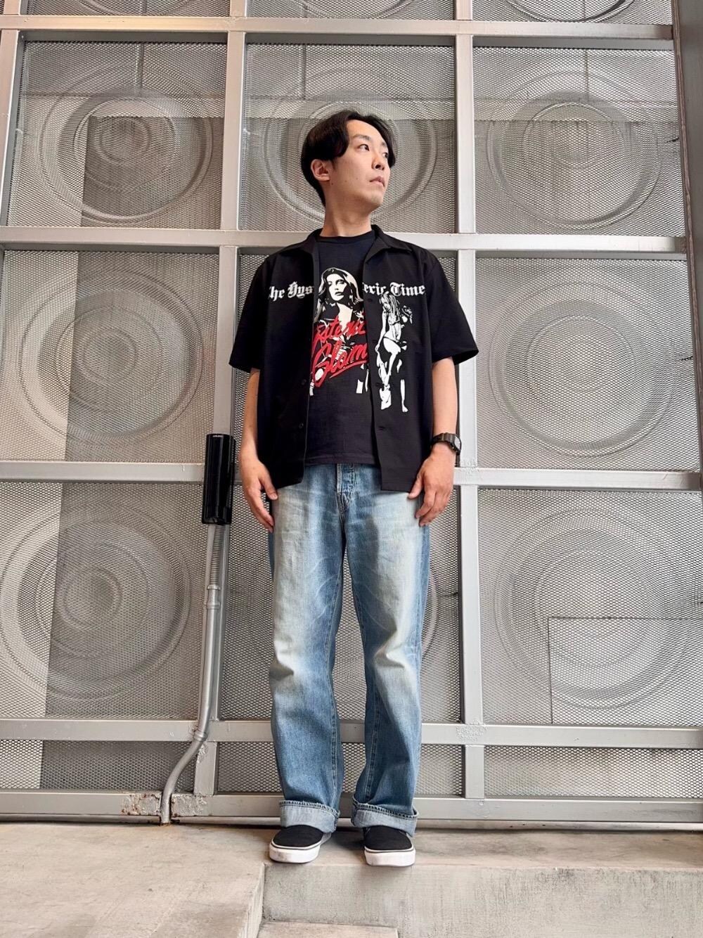 ブラック系のポロシャツ、ブルー系のデニムパンツ、ブラック系のTシャツ/カットソーを着用したメンズの春コーディネートの1枚目の写真