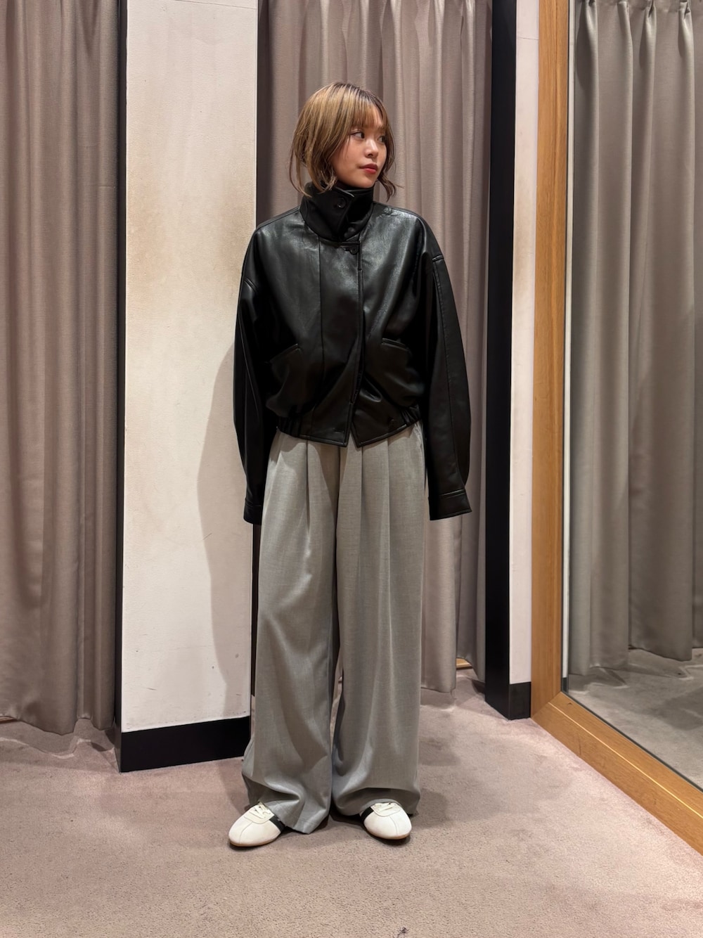 ブラック系のブルゾン、グレー系のその他パンツ、ホワイト系のスニーカーを着用したレディースの秋コーディネートの1枚目の写真