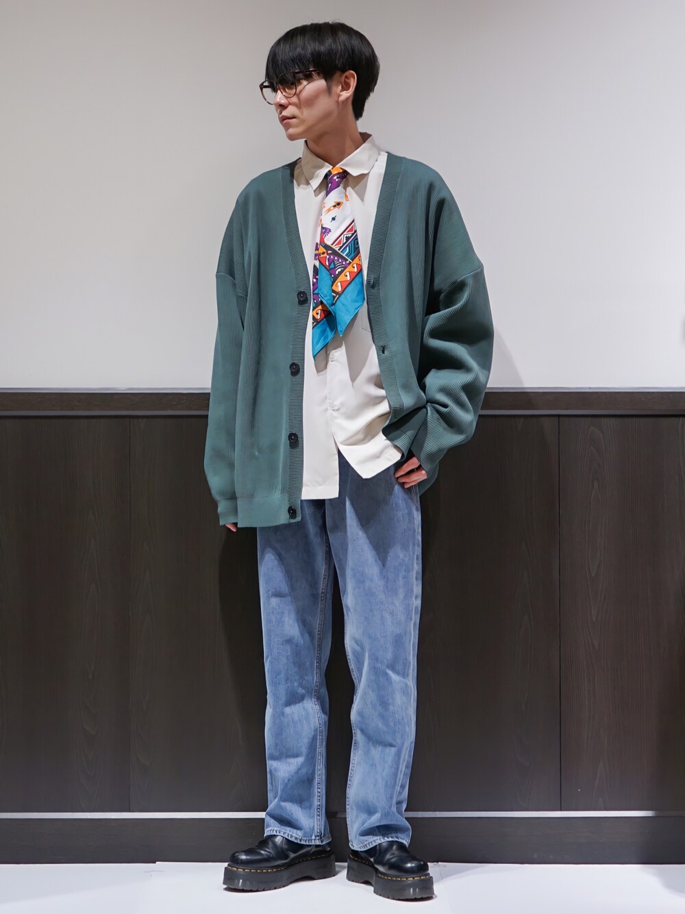 ホワイト系のシャツ/ブラウス、グリーン系のカーディガン/ボレロ、ブルー系のデニムパンツを着用したメンズの春コーディネートの1枚目の写真