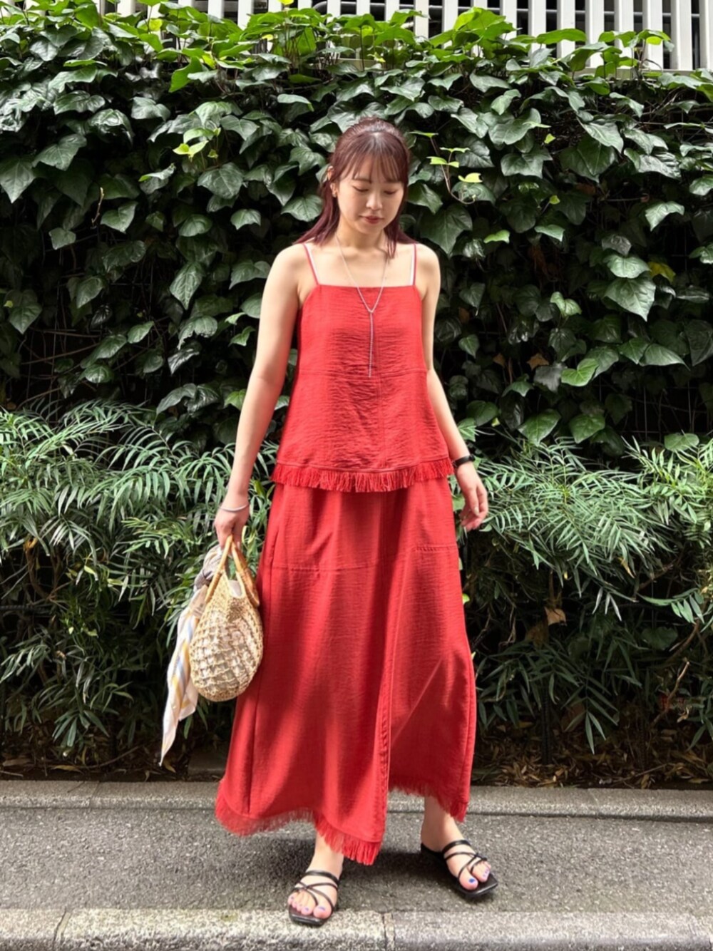 オレンジ系のワンピースを着用したレディースの夏コーディネートの1枚目の写真