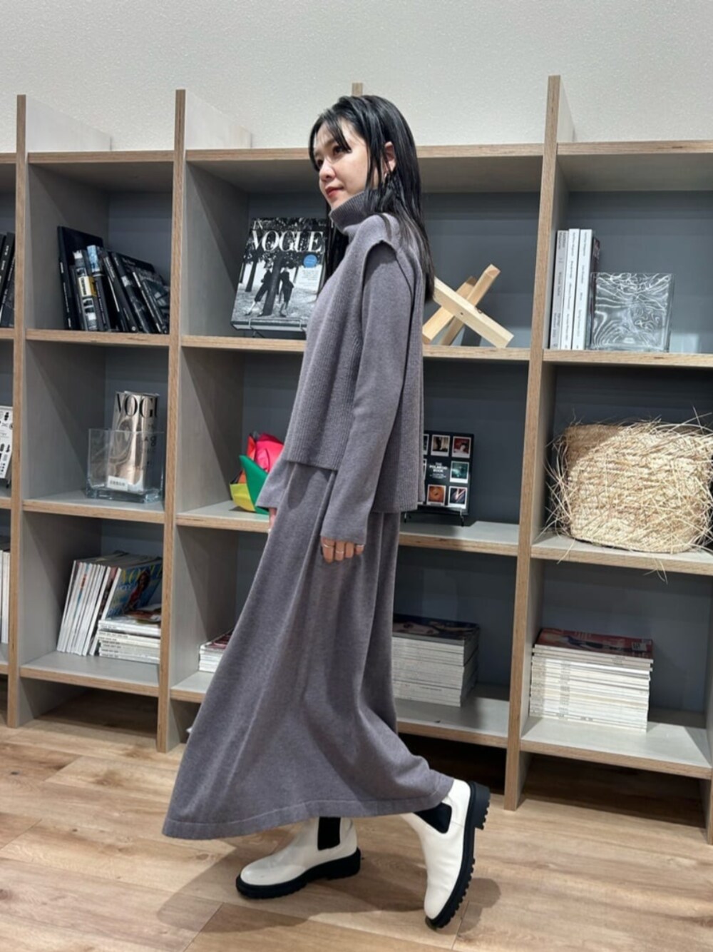 ホワイト系のブーツ、グレー系のワンピースを着用したレディースの秋コーディネートの1枚目の写真