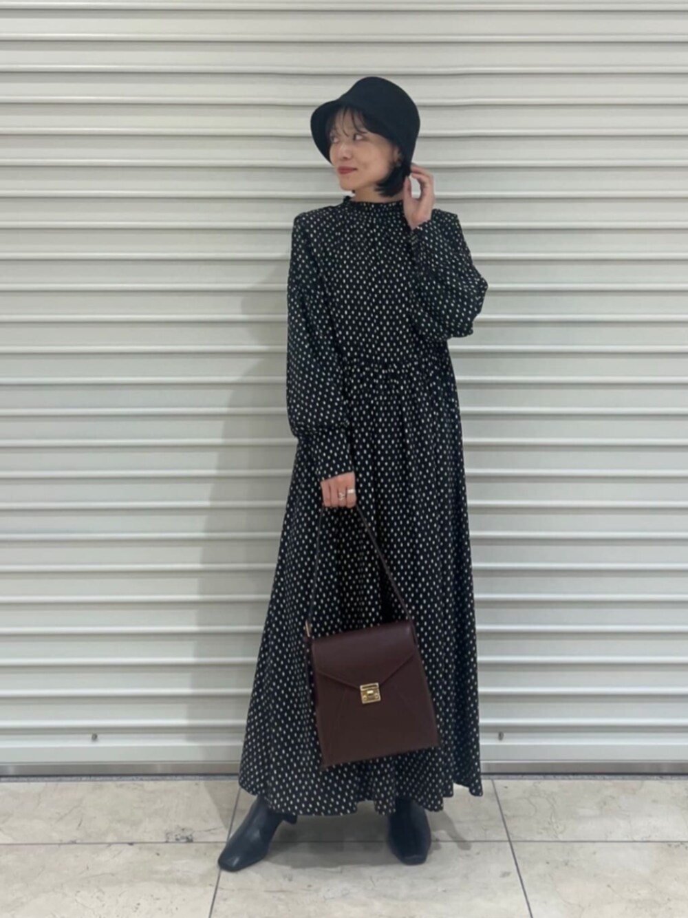 ブラック系のブーツ、その他のワンピース、ブラウン系のショルダーバッグを着用したレディースの秋コーディネートの1枚目の写真