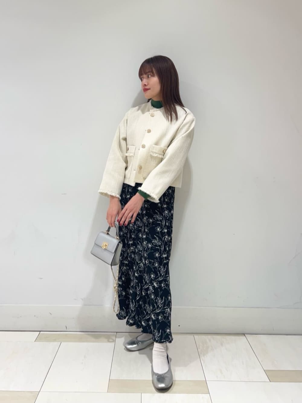 ブラック系のワンピース、ホワイト系のブルゾンを着用したレディースの冬コーディネートの1枚目の写真